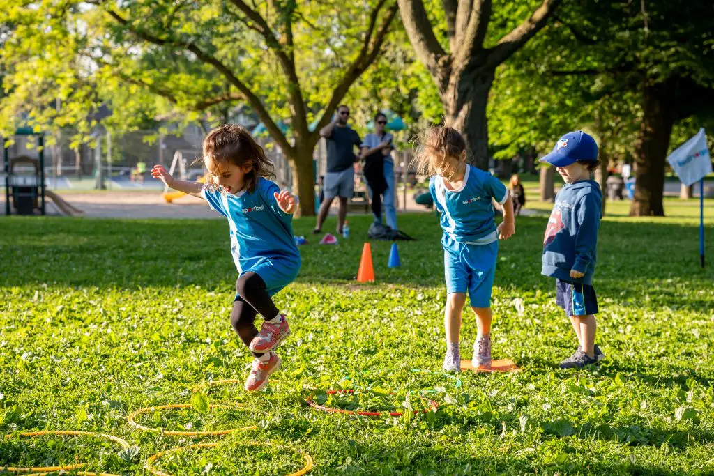 Kids jumping through a hoop