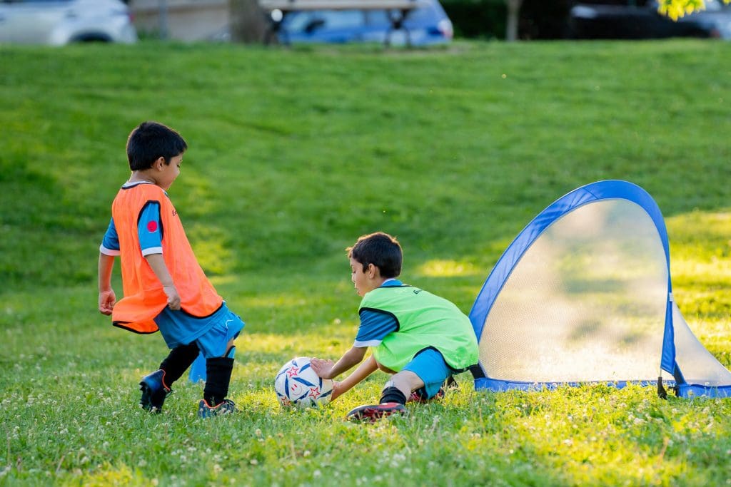 Two kids playing soccer