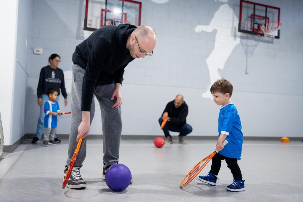 Man and child playing sports