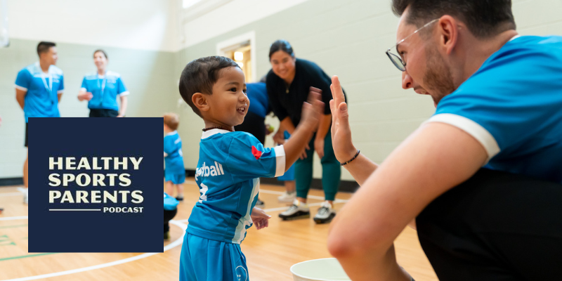 Sportball child high-fiving coach.